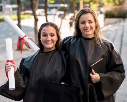 Two Girls Standing in College Dress- Abroad Study Visa
