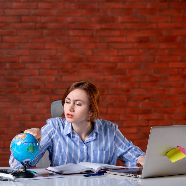Skybird International- A Girl Looking at Globe